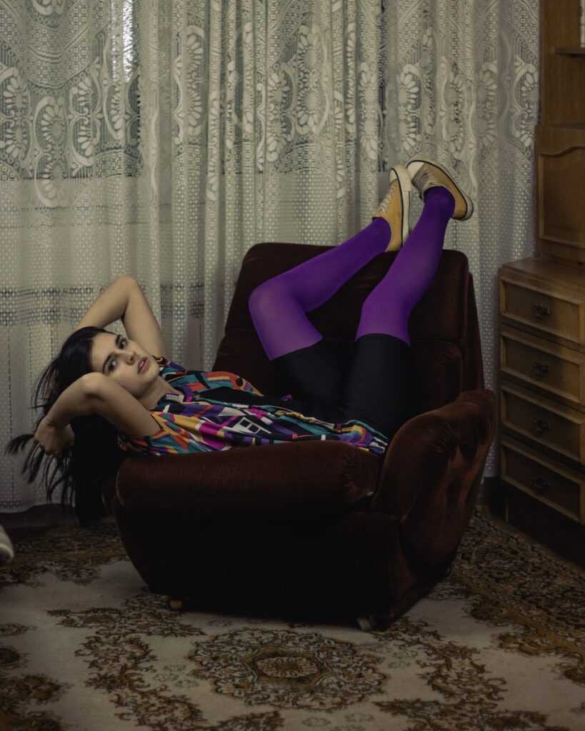 a woman laying on a chair in a room